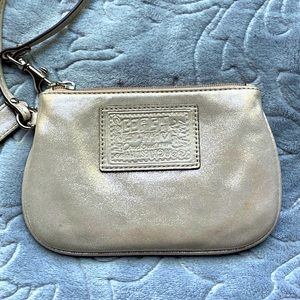Coach Wristlet in Shiny light Gold with Lilac Silky Interior.